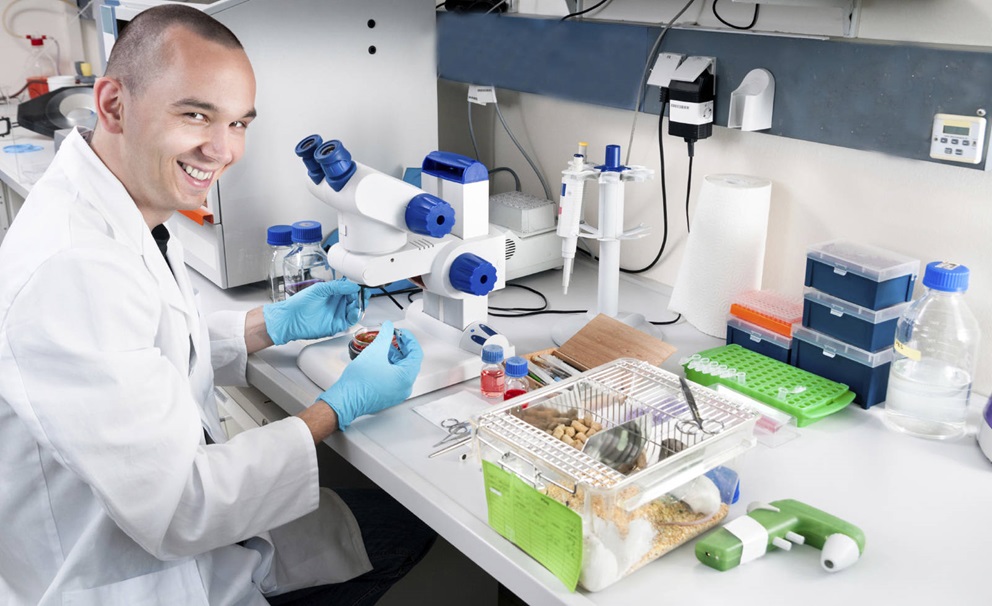 scientist with mouse cage