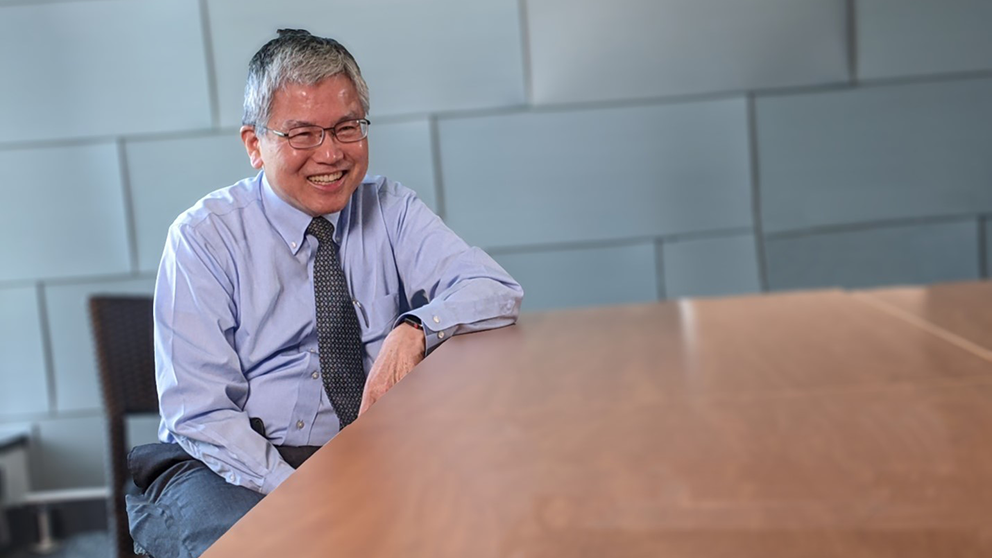 The Jackson Laboratory's Ching Lau sitting at a table.