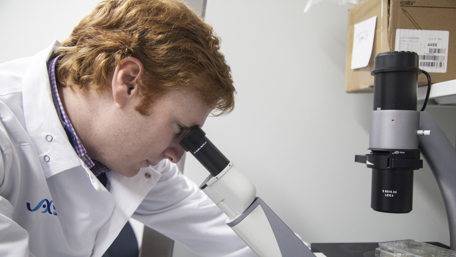 Travis Hinson at a microscope