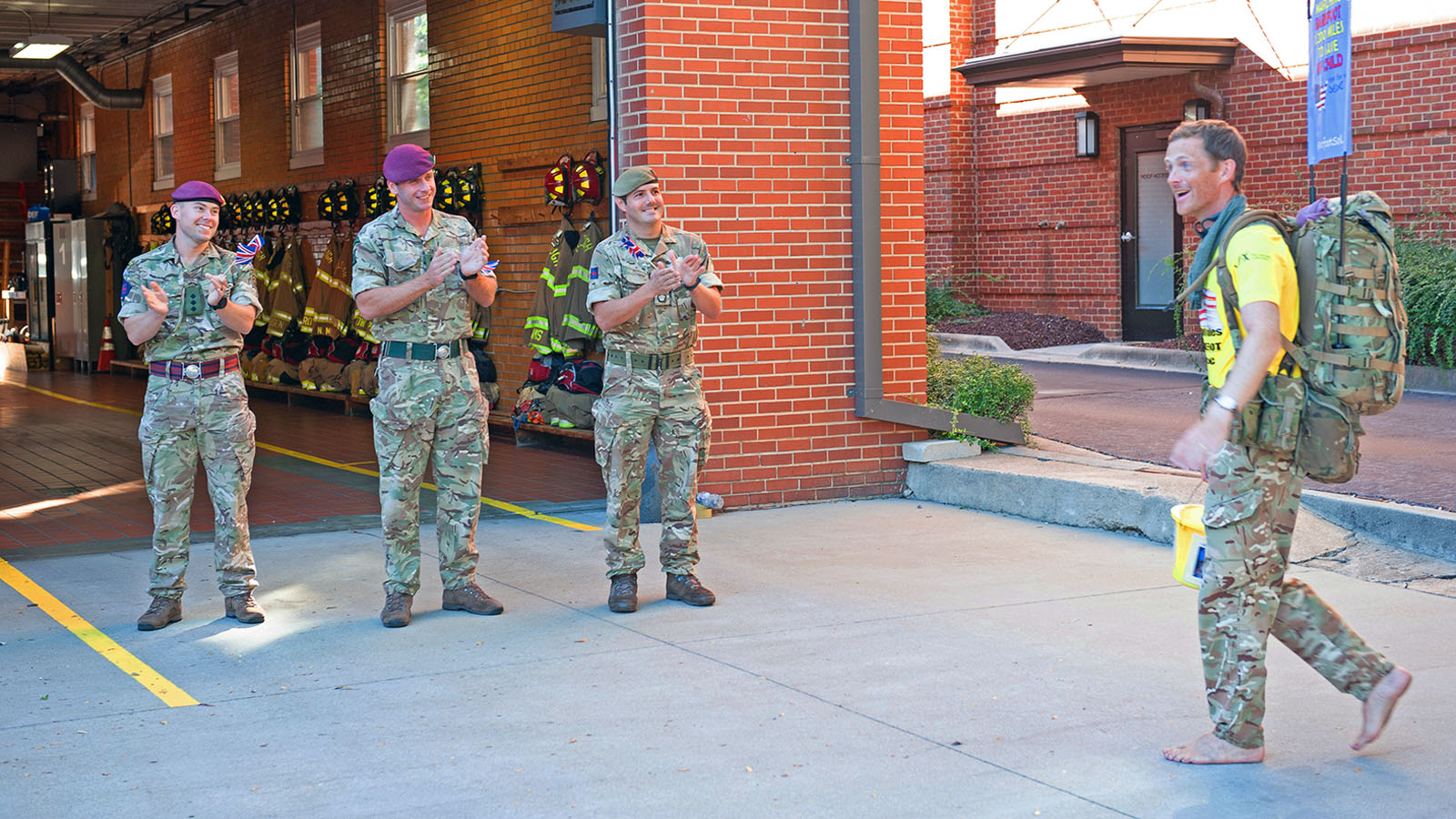 Chris Brannigan is greeted at the Raleigh fire department by North Carolina Department of Military & Veterans Affairs