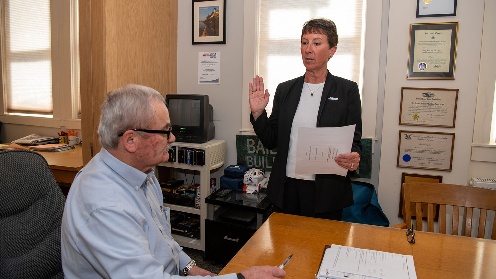 JAX employee LuAnn Ballesteros being sworn in. Dedimus Justice duties were performed by Bill Weir, president and CEO, Bar Harbor Savings and Loan.